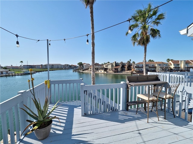 wooden deck featuring a water view and a residential view