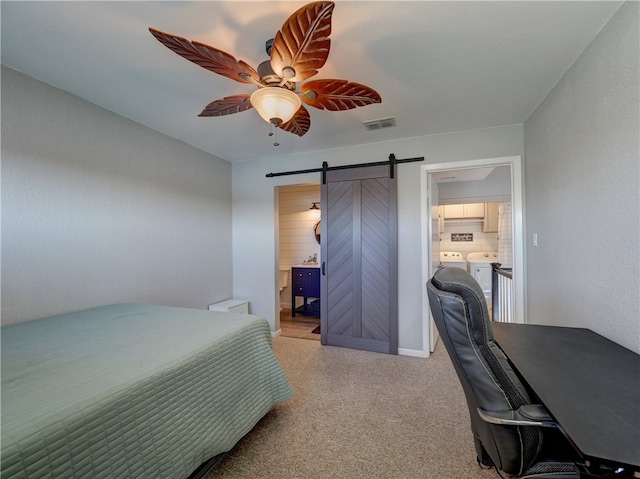 carpeted bedroom with ceiling fan, a barn door, washing machine and dryer, connected bathroom, and visible vents