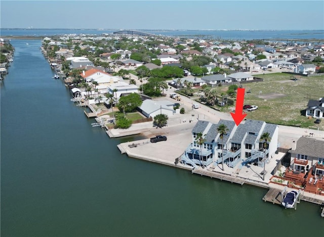 drone / aerial view featuring a water view and a residential view