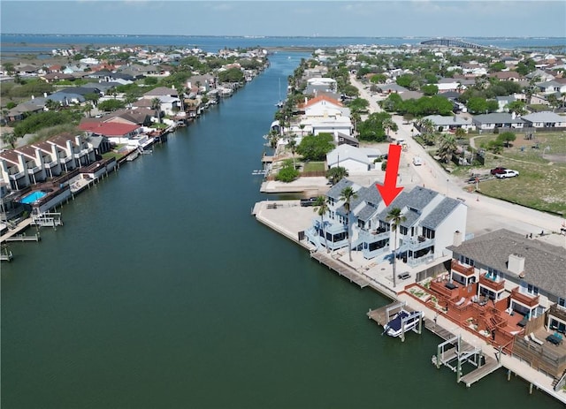 birds eye view of property with a water view and a residential view