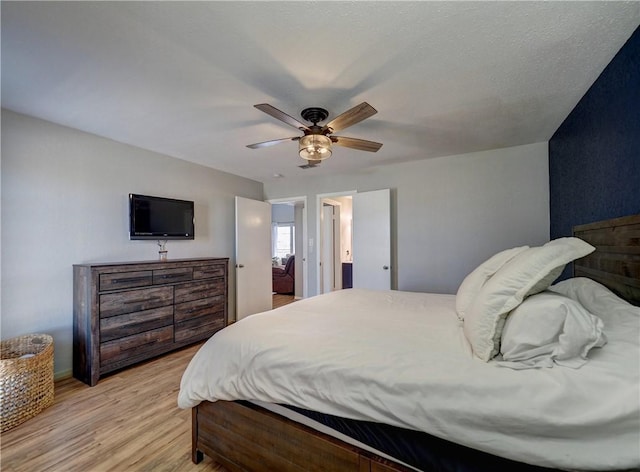 bedroom with ceiling fan and light wood-style flooring