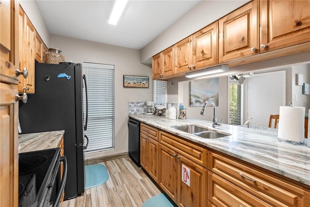 14300 Aloha St N Unit 139, Corpus Christi, TX 78418 - kitchen with electric range oven, dishwasher, light wood finished floors, light stone counters, and brown cabinetry