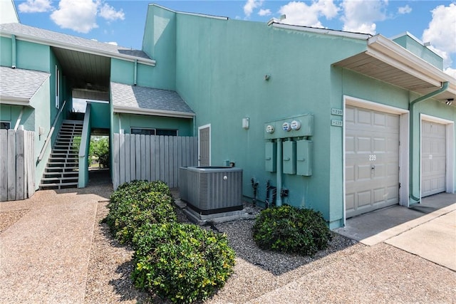 14300 Aloha St N Unit 139, Corpus Christi, TX 78418 - view of property exterior with stairs, stucco siding, driveway, and an attached garage