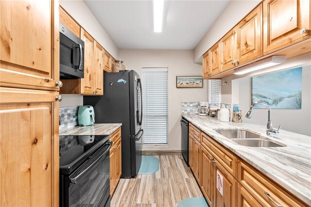 14300 Aloha St N Unit 139, Corpus Christi, TX 78418 - kitchen featuring black appliances, light wood finished floors, and light stone counters