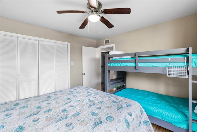 bedroom with wood-type flooring, ceiling fan, and a closet