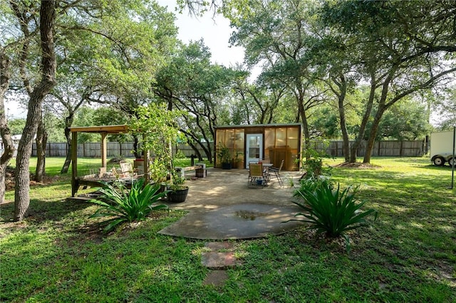 507 S Terry St, Rockport, TX 78382 - fenced backyard with an outdoor structure, a greenhouse, and a patio