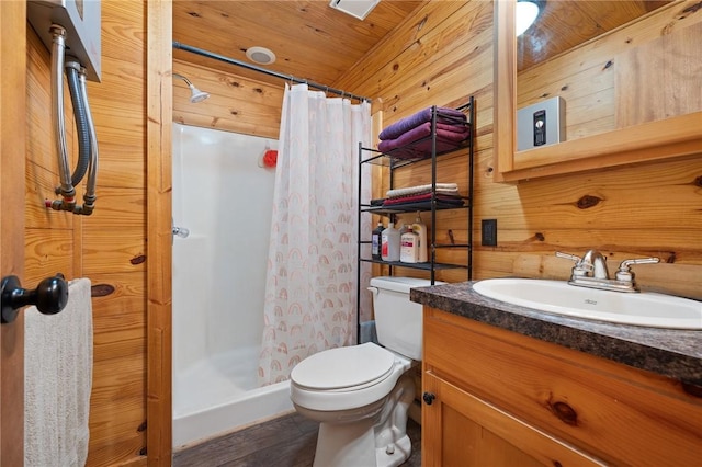 507 S Terry St, Rockport, TX 78382 - bathroom featuring vanity, a stall shower, wood finished floors, and wood walls