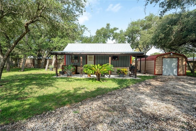 507 S Terry St, Rockport, TX 78382 - view of front of property with an outbuilding, board and batten siding, covered porch, a metal roof, and gravel driveway