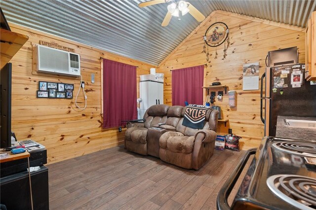 507 S Terry St, Rockport, TX 78382 - living area with wooden walls, lofted ceiling, an AC wall unit, ceiling fan, and wood finished floors