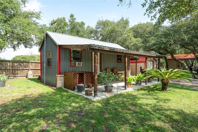 507 S Terry St, Rockport, TX 78382 - rear view of property featuring a patio area, a metal roof, and board and batten siding