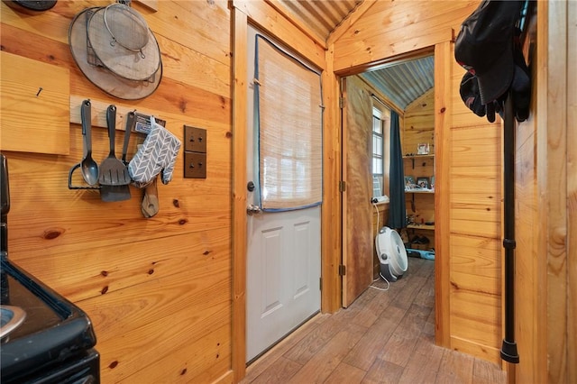 507 S Terry St, Rockport, TX 78382 - hallway featuring wood-type flooring, wooden walls, and vaulted ceiling
