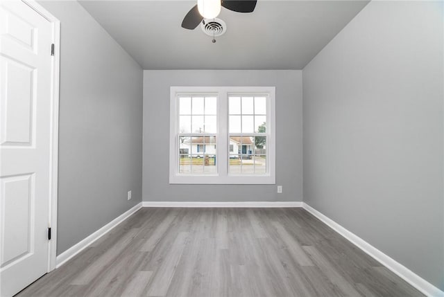 unfurnished room with visible vents, light wood-style flooring, and baseboards