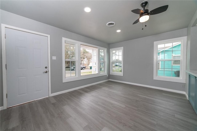 unfurnished room with baseboards, visible vents, ceiling fan, dark wood-style flooring, and recessed lighting