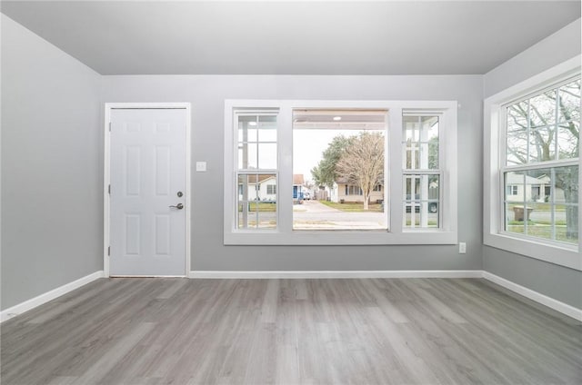 interior space featuring wood finished floors and baseboards