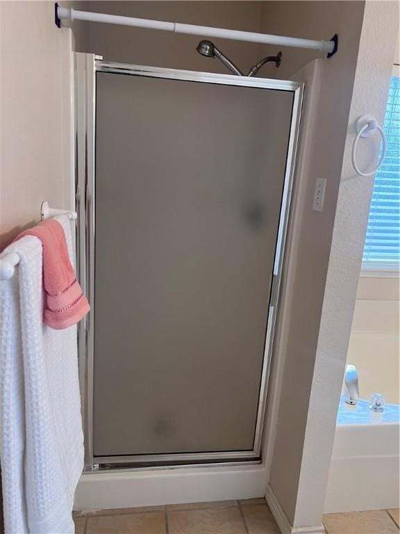 7145 Cano Ln, Corpus Christi, TX 78414 - bathroom with a stall shower, tile patterned flooring, and a garden tub
