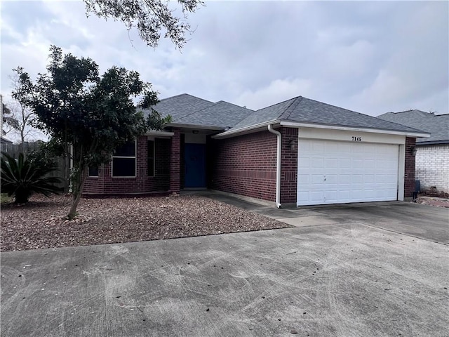 view of front of house with a garage, concrete driveway, brick siding, and roof with shingles