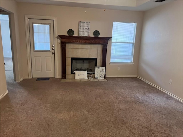 7145 Cano Ln, Corpus Christi, TX 78414 - unfurnished living room with a tile fireplace, carpet flooring, and baseboards