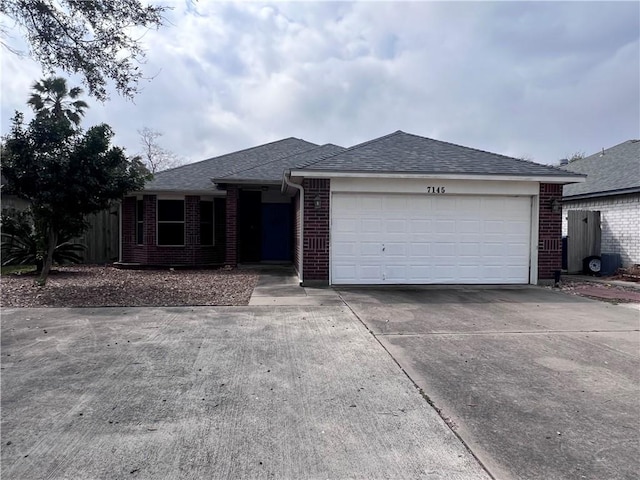 single story home featuring concrete driveway, brick siding, an attached garage, and roof with shingles