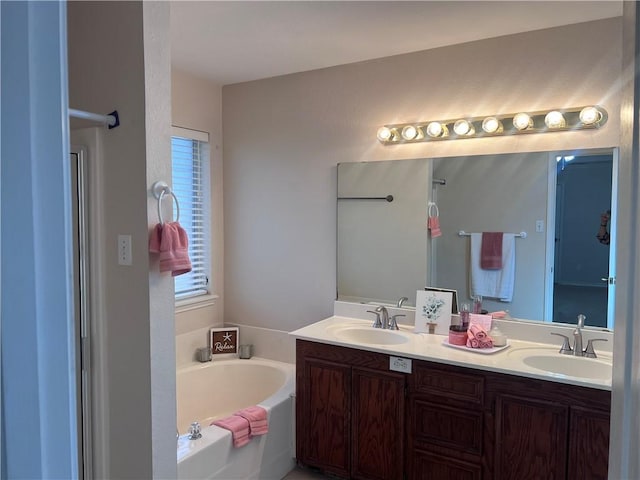 7145 Cano Ln, Corpus Christi, TX 78414 - bathroom featuring a sink, double vanity, and a garden tub