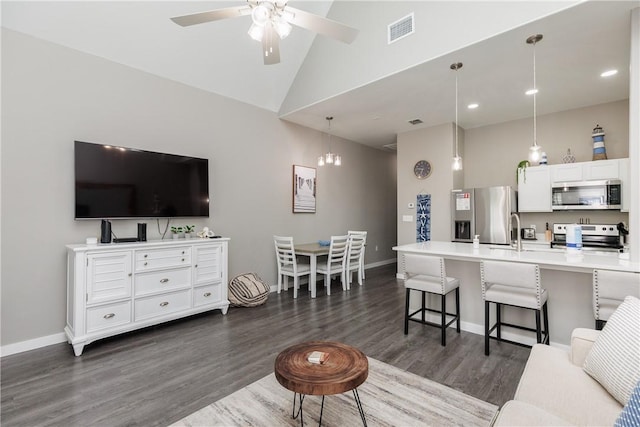 living room with baseboards, visible vents, dark wood-type flooring, and ceiling fan with notable chandelier