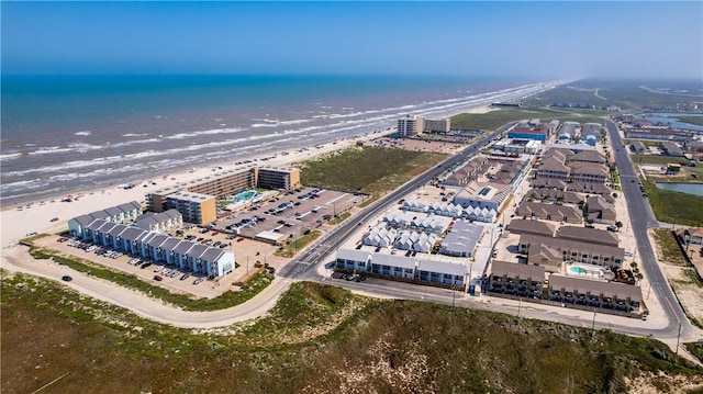 bird's eye view featuring a water view and a beach view