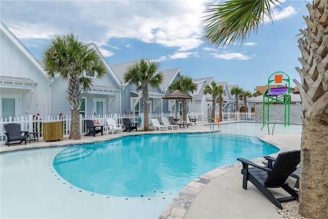 pool featuring a patio area and fence