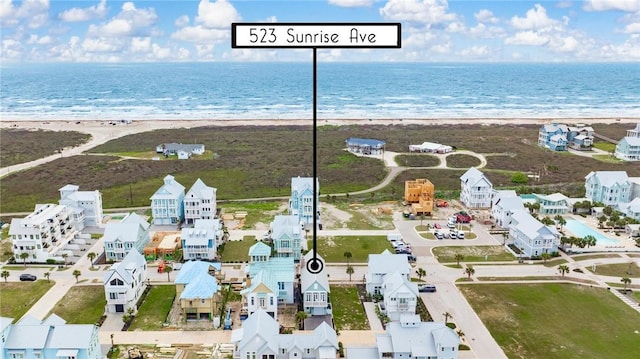 aerial view featuring a water view and a view of the beach