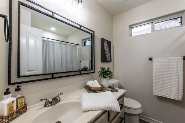 bathroom with vanity, a shower with shower curtain, and toilet