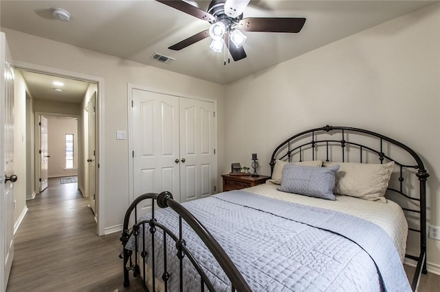 bedroom with hardwood / wood-style flooring, a closet, and ceiling fan