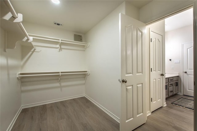 spacious closet featuring hardwood / wood-style floors