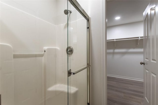 bathroom featuring hardwood / wood-style floors and walk in shower