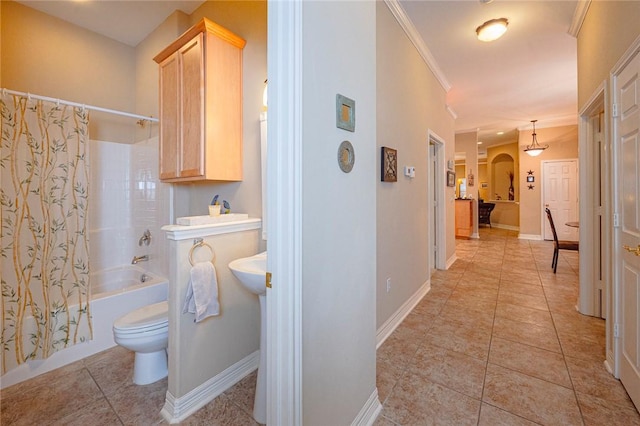 bathroom featuring shower / bath combo, tile patterned flooring, toilet, and baseboards