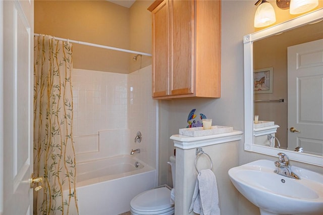 full bath with toilet, shower / bath combination with curtain, and a sink