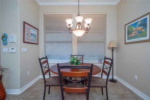 dining space featuring an inviting chandelier, baseboards, and crown molding