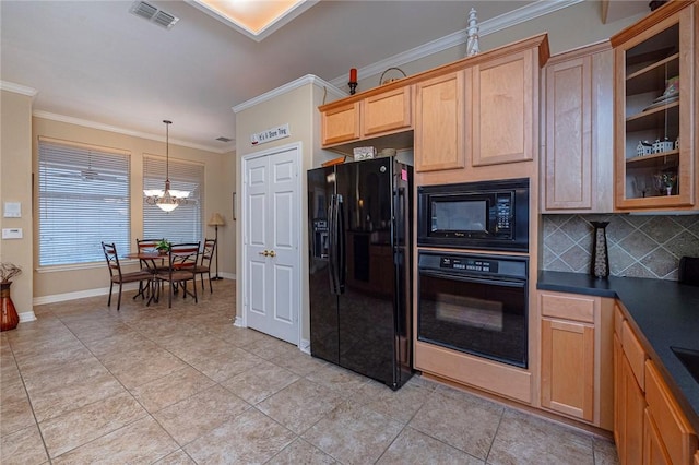 kitchen with visible vents, dark countertops, ornamental molding, black appliances, and a notable chandelier