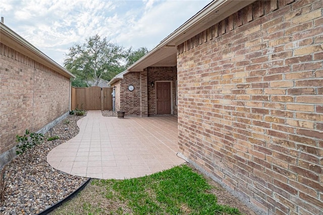 view of patio with a gate and fence