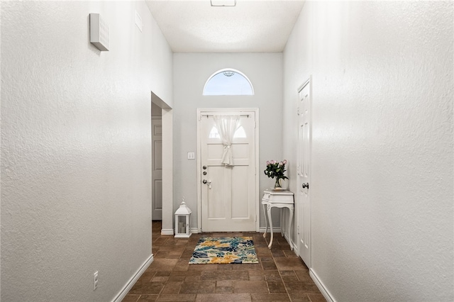 13853 Topsail St, Corpus Christi, TX 78418 - doorway to outside featuring stone finish flooring and baseboards