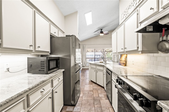 13853 Topsail St, Corpus Christi, TX 78418 - kitchen with stainless steel appliances, backsplash, a ceiling fan, light stone finish flooring, and lofted ceiling