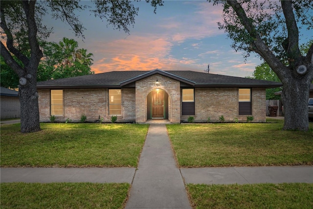 ranch-style house featuring a lawn