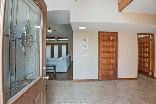 foyer entrance featuring ceiling fan and light tile patterned flooring