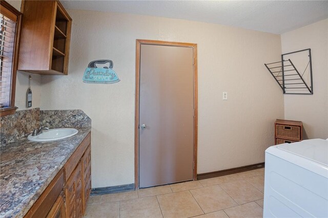 bathroom featuring tile patterned floors, washer / dryer, and vanity