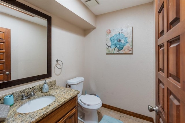 bathroom featuring vanity, tile patterned flooring, and toilet