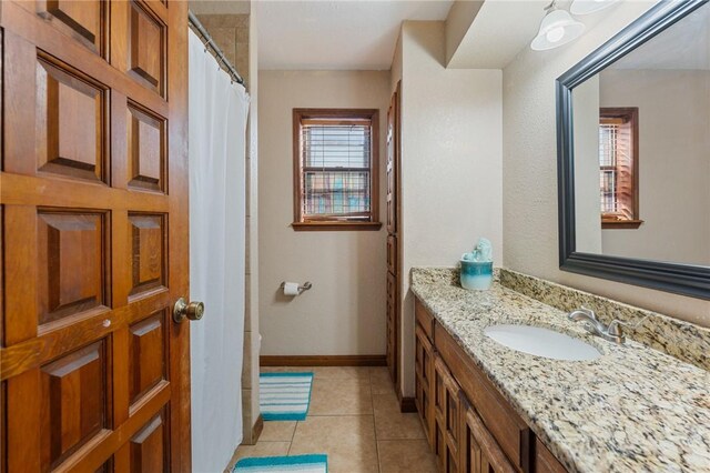 bathroom with vanity, curtained shower, and tile patterned floors