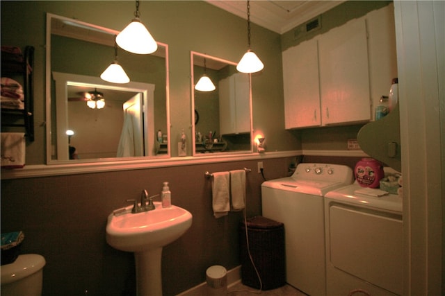 bathroom with washing machine and dryer, ceiling fan, toilet, and ornamental molding