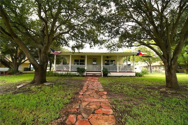 country-style home featuring a front yard and covered porch