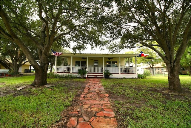 25006 Tuckers Trl, Mathis, TX 78368 - view of front facade with ceiling fan, a porch, and a front yard