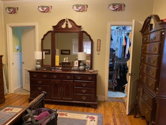 bedroom with a closet and light hardwood / wood-style flooring