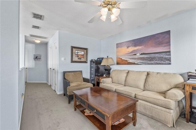 carpeted living room with ceiling fan