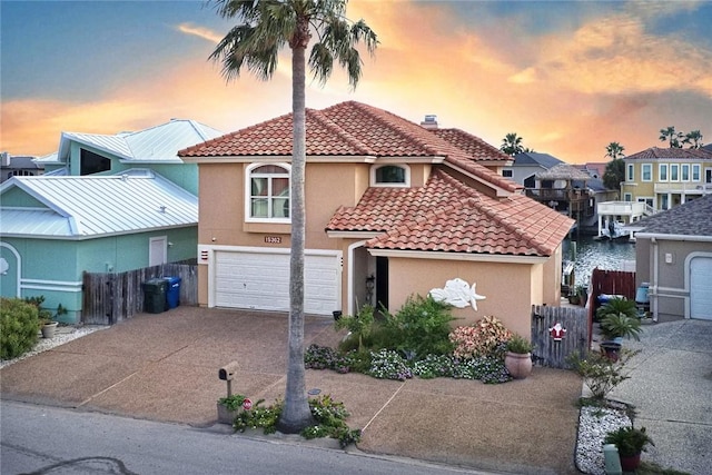 15362 Isabella Ct, Corpus Christi, TX 78418 - view of front facade with a tile roof, stucco siding, an attached garage, driveway, and a chimney