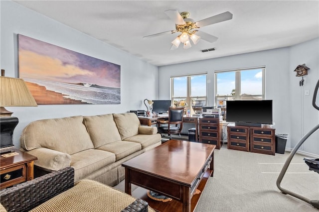 carpeted living room with ceiling fan